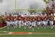 The Texas team runs onto the field before the start of an NCAA college football game against Oklahoma State, Saturday, Nov. 16, 2013, in Austin, Texas. (AP Photo/Michael Thomas)