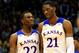LAWRENCE, KS - NOVEMBER 22: Andrew Wiggins #22 of the Kansas Jayhawks talks with Joel Embiid #21 as they walk onto the floor after a timeout during the game against the Towson Tigers at Allen Fieldhouse on November 22, 2013 in Lawrence, Kansas. (Photo by Jamie Squire/Getty Images)