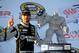 DOVER, DE - SEPTEMBER 29: Jimmie Johnson, driver of the #48 Lowe's / Kobalt Tools Chevrolet, poses with the 'Miles the Monster' trophy after winning the NASCAR Sprint Cup Series AAA 400 at Dover International Speedway on September 29, 2013 in Dover, Delaware. (Photo by Jared C. Tilton/Getty Images)
