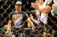 Gegard Mousasi, left, receives applause after he defats Mark Munoz from the United States in a middleweight fight during the UFC Fight Night mixed martial arts event in Berlin, Saturday, May 31, 2014. (AP Photo/Markus Schreiber)
