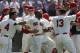 Cleveland Indians' Michael Bourn, center, celebrates with teammates after hitting a two-run home run off Colorado Rockies relief pitcher Adam Ottavino in the ninth inning of a baseball game on Sunday, June 1, 2014, in Cleveland. Indians' Mike Aviles also scored. The Indians defeated the Rockies 6-4. (AP Photo/Tony Dejak)