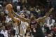 Miami Heat's LeBron James (6) fouls San Antonio Spurs' Tim Duncan (21) as he tries to steal the ball during the second half of an NBA basketball game in Miami, Sunday, Jan. 26, 2014. The Heat won 113-101. (AP Photo/J Pat Carter)