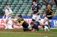 AUCKLAND, NEW ZEALAND - JUNE 02: Lloyd Greef of South Africa scores a try against Neil Herron of Scotland during the 2014 Junior World Championships match between South Africa and Scotland at QBE Stadium on June 2, 2014 in Auckland, New Zealand. (Photo by Anthony Au-Yeung/Getty Images)