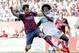 Barcelona's Cesc Fabregas, left, duels the ball with Carlos Alberto Sanchez Moreno during a Spanish La Liga soccer match at the Martinez Valero stadium in Elche, Spain, on Sunday, May 11, 2014. (AP Photo/Alberto Saiz)
