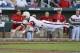 North Carolina State's Jake Armstrong leaps towards home plate before being tagged out by UCLA pitcher Nick Vander Tuig, following a single by Trea Turner in the third inning of an NCAA College World Series game in Omaha, Neb., Tuesday, June 18, 2013. (AP Photo/Ted Kirk)