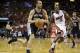San Antonio Spurs' Manu Ginobili, left, drives to the basket past Miami Heat's Mario Chalmers (15) during the first half of an NBA preseason basketball game, Saturday, Oct. 19, 2013, in Miami. (AP Photo/Lynne Sladky)