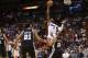 Miami Heat's Dwyane Wade (3) shoots over San Antonio Spurs' Tim Duncan (21) and Tony Parker (9) during the second half of an NBA preseason basketball game, Saturday, Oct. 19, 2013, in Miami. The Heat defeated the Spurs 121-96. (AP Photo/Lynne Sladky)