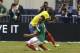 Mexico's Luis Montes collides with Ecuador's Segundo Castillo, rear, as the two were competing for the ball during the first half of a friendly soccer match, Saturday, May 31, 2014, in Arlington, Texas. Montes, who took the brunt of the collision was stretchered off the pitch after fracturing his right tibia and fibula. (AP Photo/Tony Gutierrez)