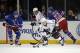 Los Angeles Kings right wing Matt Frattin (21) looks for a shot with New York Rangers center Dominic Moore (28) and New York Rangers center Brian Boyle (22) defending in the second period of their NHL hockey game at Madison Square Garden in New York, Sunday, Nov. 17, 2013. (AP Photo/Kathy Willens)