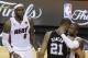 The San Antonio Spurs' Tim Duncan (21) embraces Miami Heat's Dwyane Wade (3) as Miami Heat's LeBron James (6) looks on during the first half in Game 7 of the NBA basketball championship, early Friday morning, June 21, 2013, in Miami. The Miami Heat defeated the San Antonio Spurs 95-88 to win their second straight NBA championship. (AP Photo/Steve Mitchell, Pool)