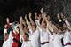 England players including Robbie Williams, left, celebrate after beating a Rest Of The World team in the Soccer Aid charity soccer match in aid of UNICEF at Old Trafford Stadium, Manchester, England, Sunday, May 27, 2012. (AP Photo/Jon Super)