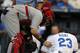 St. Louis Cardinals catcher Yadier Molina, left, checks on Kansas City Royals Norichika Aoki (23) after hitting him in the helmet with a return throw to the pitcher during the first inning of a baseball game at Kauffman Stadium in Kansas City, Mo., Thursday, June 5, 2014. (AP Photo/Orlin Wagner)