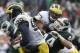 Michigan quarterback Devin Gardner (98) runs on a keeper in front of Michigan State's Marcus Rush (44) and Taylor Lewan (77) during the second quarter of an NCAA college football game, Saturday, Nov. 2, 2013, in East Lansing, Mich. (AP Photo/Al Goldis)