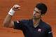 Serbia's Novak Djokovic clenches his fist as he wins the second set against Canada's Milos Raonic during their quarterfinal match of the French Open tennis tournament at the Roland Garros stadium, in Paris, France, Tuesday, June 3, 2014. (AP Photo/Michel Euler)