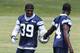Jun 12, 2012; Irving, TX, USA; Dallas Cowboys cornerback Morris Claiborne (24) hands Brandon Carr (39) his helmet during minicamp at Dallas Cowboys headquarters. Mandatory Credit: Matthew Emmons-USA TODAY Sports