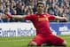 Liverpool's Luis Suarez celebrates after scoring against Everton, during their English Premier League soccer match at Goodison Park Stadium, Liverpool, England, Saturday Nov. 23, 2013. (AP Photo/Jon Super)