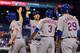 PHILADELPHIA, PA - JUNE 02: Wilmer Flores #4 of the New York Mets is congratulated by teammates David Wright #5, Curtis Granderson #3 and Eric Campbell #29 after hitting a grand slam home run in the ninth inning against the Philadelphia Phillies at Citizens Bank Park on June 2, 2014 in Philadelphia, Pennsylvania. The Mets won 11-2. (Photo by Drew Hallowell/Getty Images)