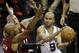 San Antonio Spurs guard Tony Parker (9) tries to pass around Miami Heat guard Ray Allen, left, and forward Chris Andersen (11) during the second half in Game 1 of the NBA basketball finals on Thursday, June 5, 2014 in San Antonio. (AP Photo/Tony Gutierrez)