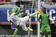United States's Clint Dempsey (8) takes a shot on goal as he is defended by Nigeria's Efe Ambrose, center, as Joseph Yobo (2) looks on during the first half of an international friendly soccer match in Jacksonville, Fla., Saturday, June 7, 2014. (AP Photo/John Raoux)