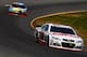 LONG POND, PA - JUNE 08: Dale Earnhardt Jr., driver of the #88 National Guard Chevrolet, leads Kyle Busch, driver of the #18 M&M's Peanut Butter Toyota, during the NASCAR Sprint Cup Series Pocono 400 at Pocono Raceway on June 8, 2014 in Long Pond, Pennsylvania. (Photo by Jeff Zelevansky/Getty Images)