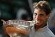 Spain's Rafael Nadal bites the trophy after winning the final of the French Open tennis tournament against Serbia's Novak Djokovic at the Roland Garros stadium, in Paris, France, Sunday, June 8, 2014. Nadal won in four sets 3-6, 7-5, 6-2, 6-4. (AP Photo/Darko Vojinovic)