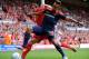 LIVERPOOL, ENGLAND - AUGUST 12: Jose Enrique (L) of Liverpool and Karim Bellarabi (R) of Bayer Leverkusen battle for the ball during the pre season friendly match between Liverpool and Bayer Leverkusen at Anfield on August 12, 2012 in Liverpool, England. (Photo by Clint Hughes/Getty Images)