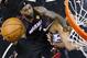 Miami Heat forward LeBron James shoots over San Antonio Spurs forward Tim Duncan (21) during the first half in Game 2 of the NBA basketball finals on Saturday, Nov. 8, 2014, in San Antonio. (AP Photo/Larry W. Smith, pool)