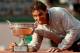 PARIS, FRANCE - JUNE 08: Rafael Nadal of Spain bites the Coupe de Mousquetaires after victory in his men's singles final match against Novak Djokovic of Serbia on day fifteen of the French Open at Roland Garros on June 8, 2014 in Paris, France. (Photo by Matthew Stockman/Getty Images)
