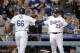 Los Angeles Dodgers' Yasiel Puig, left, celebrates his home run with Adrian Gonzalez during the sixth inning of a baseball game against the Cincinnati Reds on Wednesday, May 28, 2014, in Los Angeles. (AP Photo/Jae C. Hong)