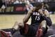Miami Heat guard Mario Chalmers (15) recovers after hitting the floor against the San Antonio Spurs during the first half in Game 2 of the NBA basketball finals on Sunday, June 8, 2014, in San Antonio. (AP Photo/Eric Gay)