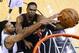 Miami Heat center Chris Bosh shoots as San Antonio Spurs forward Tim Duncan, left, defends during the first half in Game 2 of the NBA basketball finals on Saturday, Nov. 8, 2014, in San Antonio. (AP Photo/Larry W. Smith, pool)