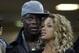 AC Milan striker Mario Balotelli and his girlfriend Fanny Neguesha wait for the start of the Champions League round of 16, first leg soccer match between AC Milan and Barcelona, at the San Siro stadium in Milan, Italy, Wednesday, Feb. 20, 2013. (AP Photo/Luca Bruno)
