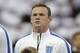 England's Wayne Rooney stands in a team line up during the playing of the national anthems before the international friendly soccer match between England and Peru at Wembley Stadium in London, Friday, May 30, 2014. (AP Photo/Matt Dunham)