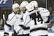 Los Angeles Kings, from left, Alec Martinez (27), Dwight King (74), Jeff Carter, and Justin Williams (14) celebrate after a goal by Carter against the New York Rangers to end the first period during Game 3 of the NHL hockey Stanley Cup Final, Monday, June 9, 2014, in New York. (AP Photo/Kathy Willens)