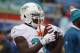 Miami Dolphins running back Lamar Miller (26) warms up before an NFL football game against the Buffalo Bills on Sunday, Dec. 22, 2013, in Orchard Park, N.Y. (AP Photo/Bill Wippert)