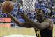Wichita State's Cleanthony Early (11) heads to the basket as Saint Louis' Grandy Glaze (1), Dwayne Evans (21) and Jordair Jett (5) defend during the second half of an NCAA college basketball game Sunday, Dec. 1, 2013, in St. Louis. Wichita State won 70-65. (AP Photo/Jeff Roberson)