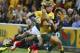 Australian left wing Nick Cummins, left, is tackled by French fullback Hugo Bonneval during their Rugby test match in Brisbane, Australia, Saturday, June 7, 2014. (AP Photo/Tertius Pickard)