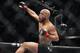Defending champ Demetrious Johnson celebrates after knocking out Joseph Benavidez in the first round of their UFC flyweight mixed martial arts title fight in Sacramento, Calif., Saturday, Dec. 14, 2013. (AP Photo/Steve Yeater)