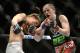 Apr 16, 2014; Quebec City, Quebec, Canada; Sarah Kaufman ( red gloves) Victoria, BC,Canada take a hit Leslie Smith (blue gloves), Pleasant Hiil, CA during their women's bantamweight bout at Colisee Pepsi. Mandatory Credit: Eric Bolte-USA TODAY Sports