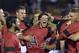 Louisville's Nick Solak, center right, hugs teammate Logan Taylor after the team's 7-4 victory over Kennesaw State to win the NCAA college baseball tournament Louisville super regional game in Louisville, Ky., Saturday, June 7, 2014. (AP Photo/Timothy D. Easley)