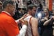 Auburn's new men's basketball coach, Bruce Pearl, autographs Clay Fleming's shirt Tuesday, March 18, 2014, in Auburn, Ala. (AP Photo/Butch Dill)