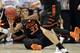 Oklahoma State's Marcus Smart passes to a teammate after diving for a loose ball against Gonzaga during the second half in a second-round game in the NCAA college basketball tournament Friday, March 21, 2014, in San Diego. (AP Photo/Gregory Bull)