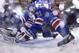 New York Rangers center Derek Stepan (21) reaches to move the puck away from the goal behind goalie Henrik Lundqvist (30) in the third period during Game 4 of the NHL hockey Stanley Cup Final, Wednesday, June 11, 2014, in New York. The Rangers won the game 2-1. (AP Photo/Bruce Bennett, Pool)