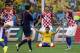 Brazil's Fred sits on the pitch as Croatian players Vedran Corluka (5), Dejan Lovren (6) and Ivan Rakitic (7) protest after referee Yuichi Nishimura, from Japan, called a penalty against Croatia during the group A World Cup soccer match in the opening game of the tournament at Itaquerao Stadium in Sao Paulo, Brazil, Thursday, June 12, 2014. Brazil's Neymar scored on a penalty kick after the play. (AP Photo/Frank Augstein)
