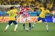SAO PAULO, BRAZIL - JUNE 12: Ivan Rakitic of Croatia controls the ball against Neymar (L) and Oscar of Brazil (R) during the 2014 FIFA World Cup Brazil Group A match between Brazil and Croatia at Arena de Sao Paulo on June 12, 2014 in Sao Paulo, Brazil. (Photo by Buda Mendes/Getty Images)