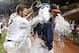 Virginia head coach Brian O'Connor gets doused with water by Virginia's Branden Cogswell (7) after Virginia defeated Maryland 11-2 to win the NCAA Super Regional baseball game in Charlottesville, Va., Monday, June 9, 2014. (AP Photo/Steve Helber)