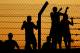 LE MANS, FRANCE - JUNE 12: Fans scale the fence during qualifying session to get a closer looks at the action on June 12, 2014 in Le Mans, France. (Photo by Andrew Hone/Getty Images)