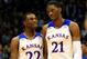 LAWRENCE, KS - NOVEMBER 22: Andrew Wiggins #22 of the Kansas Jayhawks talks with Joel Embiid #21 as they walk onto the floor after a timeout during the game against the Towson Tigers at Allen Fieldhouse on November 22, 2013 in Lawrence, Kansas. (Photo by Jamie Squire/Getty Images)