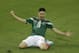 Mexico's Oribe Peralta celebrates after scoring during the group A World Cup soccer match between Mexico and Cameroon in the Arena das Dunas in Natal, Brazil, Friday, June 13, 2014. (AP Photo/Hassan Ammar)