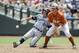 UC Irvine's Grant Palmer (27) reaches second base on a double against Texas second baseman Brooks Marlow (8), in the second inning of an NCAA baseball College World Series game in Omaha, Neb., Saturday, June 14, 2014. (AP Photo/Dave Weaver)